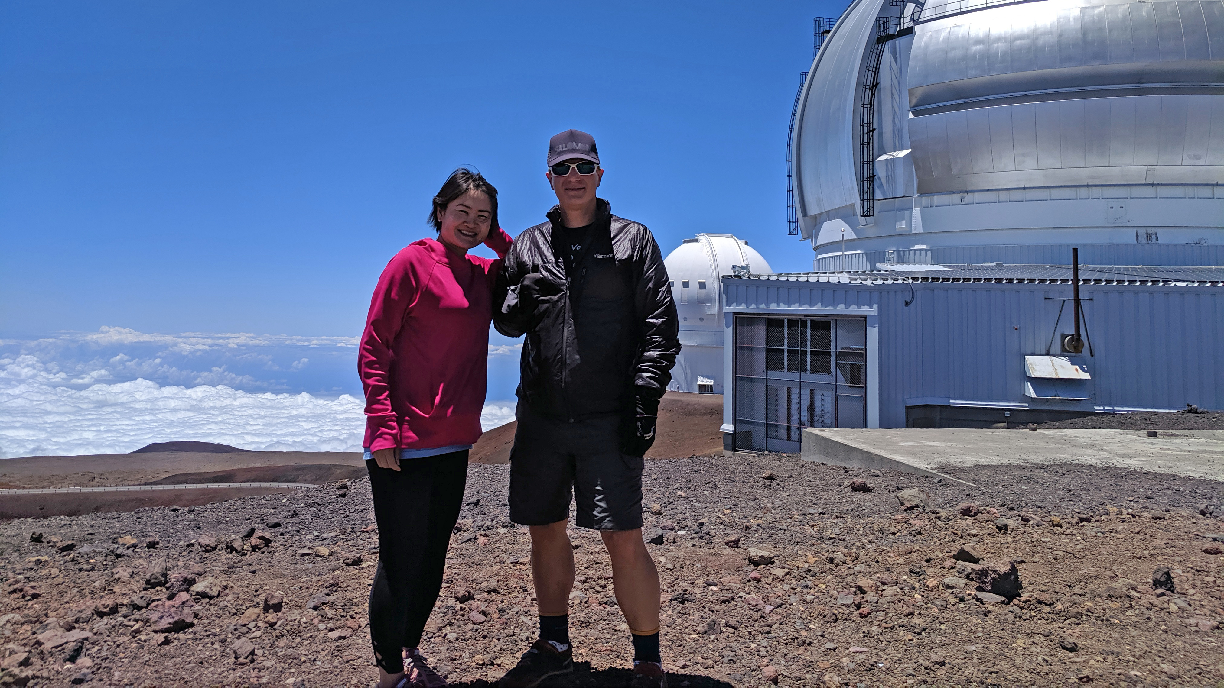 Clint and a friend stand near the observatories on Maunakea Volcano in Hawaiʻi.